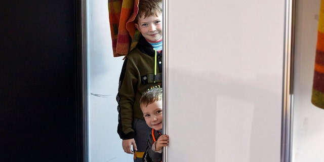 Children from Ukraine smile at a facility for refugees in Chisinau, Moldova, Monday, Feb. 28, 2022.