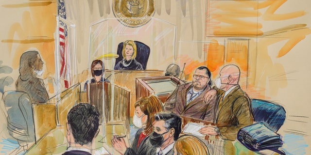 This artist sketch depicts Judge Dabney Friedrich looking out from the bench during jury selection for Guy Wesley Reffitt, joined by his lawyer William Welch, top right, in Federal Court, in Washington, Monday, Feb. 28, 2022.