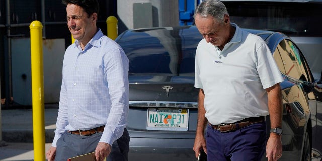Major League Baseball Deputy Commissioner Dan Halem, left, and Commissioner Rob Manfred, right, walk after negotiations with the players association in an attempt to reach an agreement to salvage March 31 openers and a 162-game season, Monday, Feb. 28, 2022, at Roger Dean Stadium in Jupiter, Fla.