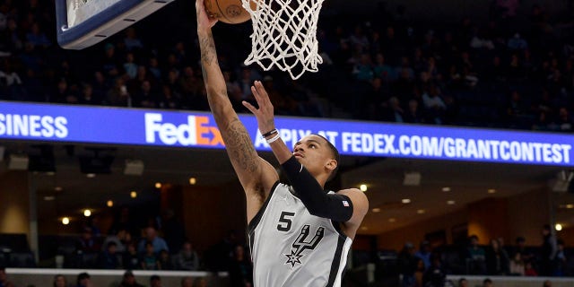 San Antonio Spurs guard Dejounte Murray shoots a layup during the first half of the team's NBA basketball game against the Memphis Grizzlies on Monday, Feb. 28, 2022, in Memphis, Tenn.