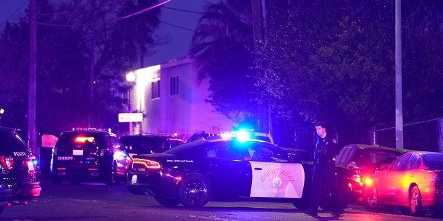 Law enforcement vehicles from several agencies block a street near the scene of a shooting in Sacramento, Calif., Monday, Feb. 28, 2022.