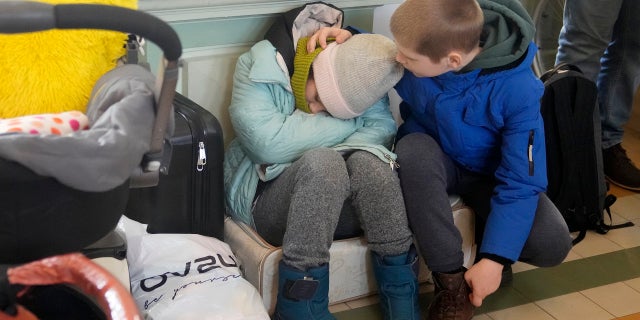 Refugees from Ukraine rest at the railway station in Przemysl, Poland, Tuesday, March 1, 2022.
