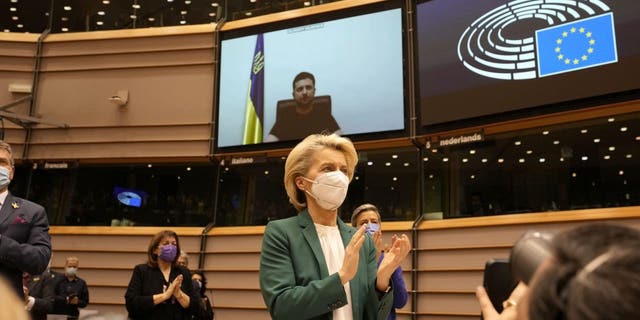 European Commission President Ursula von der Leyen applauds after an address by Ukraine's President Volodymyr Zelenskyy, via video link, during an extraordinary session on Ukraine at the European Parliament in Brussels, Tuesday, March 1, 2022. 