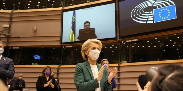 European Commission President Ursula von der Leyen applauds after an address by Ukraine's President Volodymyr Zelenskyy, via video link, during an extraordinary session on Ukraine at the European Parliament in Brussels, Tuesday, March 1, 2022.