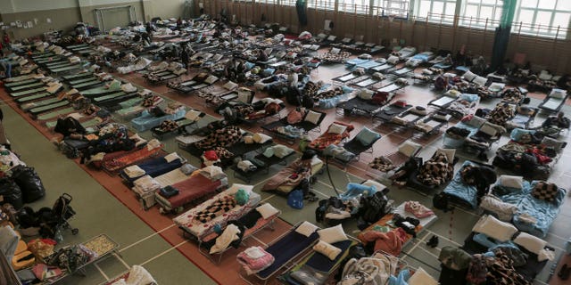 Hundreds of beds are shown placed inside a sports hall to accommodate Ukrainian refugees fleeing the Russian invasion at the border crossing town of Medyka, Poland, on Tuesday, March 1, 2022.
