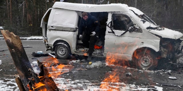 A man leaves a vehicle damaged by shelling in Brovary, outside Kyiv, Ukraine, Tuesday, March 1, 2022. 