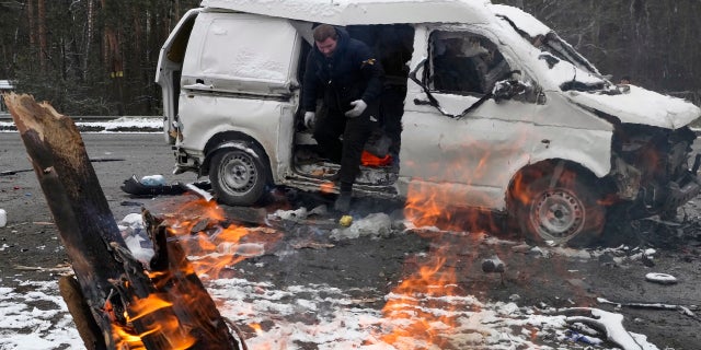 A man leaves a vehicle damaged by shelling in Brovary, outside Kyiv, Ukraine, Tuesday, March 1, 2022.