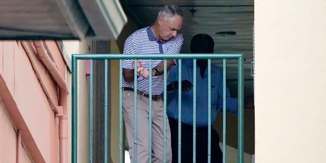 Major League Baseball Commissioner Rob Manfred practices his golf swing as negotiations continue with the players' association toward a labor deal, Tuesday, March 1, 2022, at Roger Dean Stadium in Jupiter, Fla.
