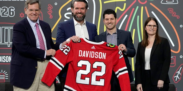 The Chicago Blackhawks management team, from left, Chairman Rocky Wirtz, CEO Danny Wirtz, general manager Kyle Davidson, and president of business operations Jamie Faulkner stand for a photo after naming Davidson as the team's new general manager during an NHL hockey news conference Tuesday, March 1, 2022, in Chicago. Davidson becomes the team's 10th general manager after dropping his interim tag instead of going outside the franchise for new leadership. Davidson has been with the Blackhawks since he joined the organization as a hockey operations intern in 2010.