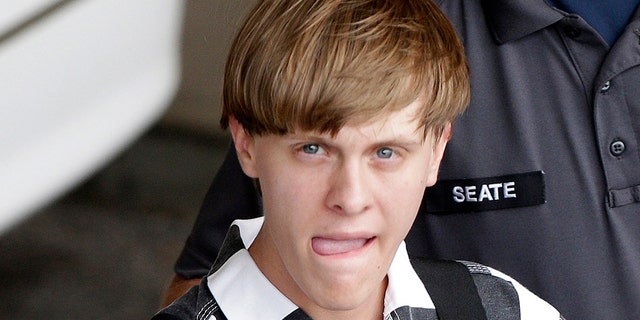 FILE - In this June 18, 2015, file photo, Charleston, S.C., shooting suspect Dylann Storm Roof is escorted from the Cleveland County Courthouse in Shelby, N.C. 