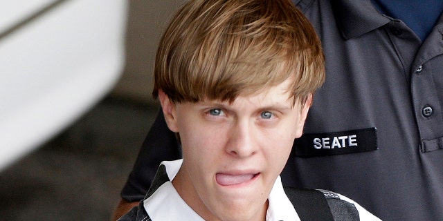 FILE - In this June 18, 2015, file photo, Charleston, S.C., shooting suspect Dylann Storm Roof is escorted from the Cleveland County Courthouse in Shelby, N.C.