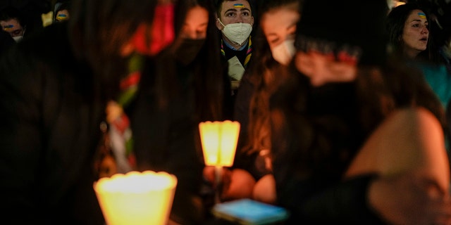 People hold candles as they take part in a prayer vigil to protest against the Russian invasion of Ukraine, in St.Peter's Square, at the Vatican, Wednesday, March 2, 2022.