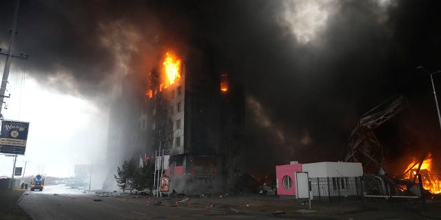 A building burns after shelling in Kyiv, Ukraine, Thursday, March 3, 2022. Russia has launched a wide-ranging attack on Ukraine, hitting cities and bases with airstrikes or shelling.
