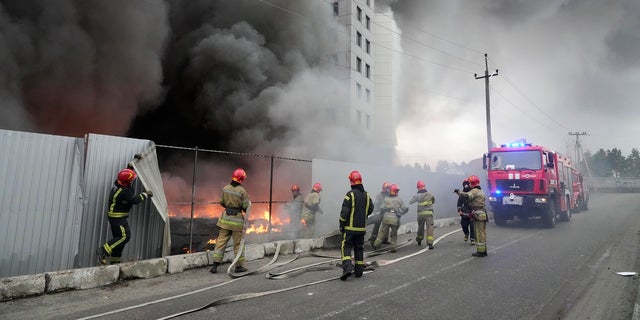 Firefighters work to extinguish a fire at a damaged logistics center after shelling in Kyiv, Ukraine, March 3, 2022.