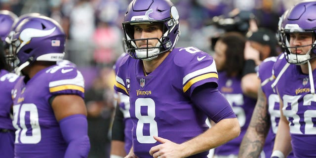 FILE - Minnesota Vikings quarterback Kirk Cousins (8) runs on the field before an NFL football game against the Chicago Bears, Sunday, Jan. 9, 2022, in Minneapolis. New Minnesota Vikings general manager Kwesi Adofo-Mensah's first season with the Vikings will be a tall task given their current commitments. Kirk Cousins is currently carrying a $45 million salary cap charge on the final year of his existing contract.