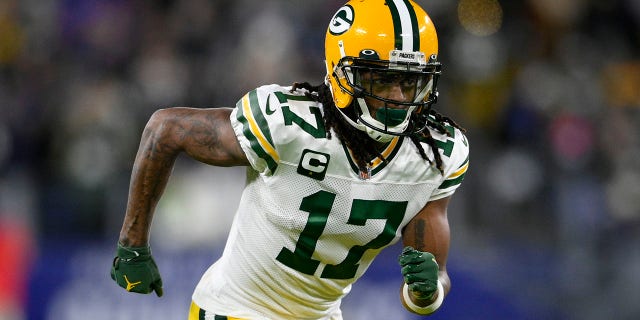 FILE - Green Bay Packers wide receiver Davante Adams runs on the field in the first half of an NFL football game against the Baltimore Ravens, Sunday, Dec. 19, 2021, in Baltimore. The Packers have several moves to make this month to not only get under the salary cap but also have enough room for a new contract to keep Adams, the All-Pro wide receiver who can become a free agent