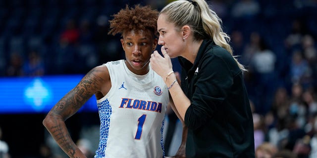 Florida head coach Kelly Rae Finley talks with Kiara Smith (1) in the first half of an NCAA college basketball game against Vanderbilt at the women's Southeastern Conference tournament Thursday, March 3, 2022, in Nashville, Tenn.