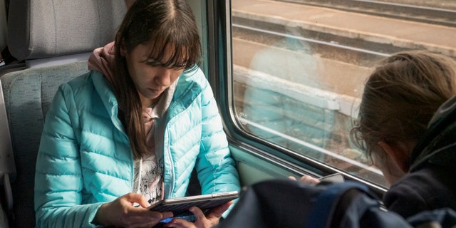 Olena, a Russian citizen fleeing from Kyiv, Ukraine (no family name given for safety resson) sits on a train while traveling from the Hungarian - Ukrainian border towards Budapest on Thursday, March. 3, 2022.