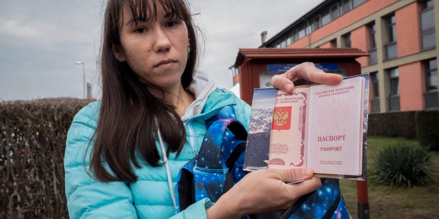 Olena, a Russian citizen fleeing from Kyiv, Ukraine (no family name given for safety reson) shows her Russian passport after arriving at the outskirt of Budapest, Hungary on Friday, March. 4, 2022.