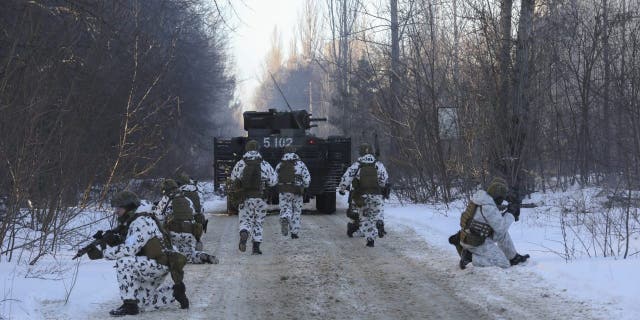 La Guardia Nacional, las Fuerzas Armadas y las unidades de operaciones especiales de Ucrania simulan una situación de crisis en un asentamiento urbano en la ciudad abandonada de Pripyat, cerca de la planta de energía nuclear de Chernobyl, Ucrania, el 4 de febrero de 2022. 