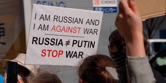 People hold banners during a march denouncing Russian invasion on Ukraine, in Tokyo, Saturday, March 5, 2022. (AP Photo/Chisato Tanaka)