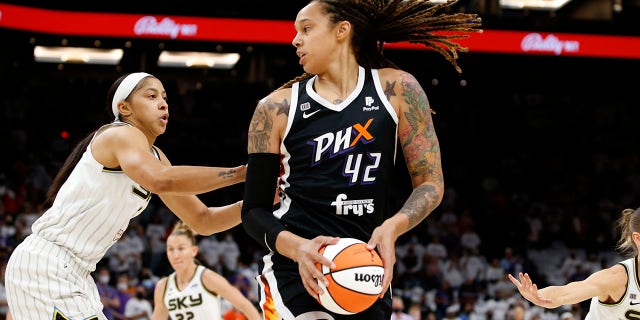 FILE - Phoenix Mercury center Brittney Griner (42) looks to pass as Chicago Sky center Candace Parker defends during the first half of game 1 of the WNBA basketball Finals , Sunday, Oct. 10, 2021, in Phoenix.