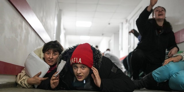 People lie on the floor of a hospital during shelling by Russian forces in Mariupol, Ukraine, Friday, March 4, 2022.