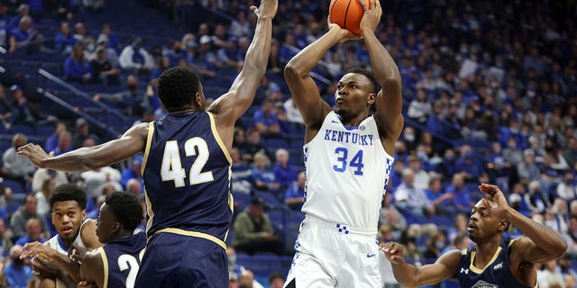 FILE - Kentucky's Oscar Tshiebwe (34) shoots between Mount St. Mary's Malik Jefferson (42) and Josh Reaves (23) during the first half of an NCAA college basketball game in Lexington, Ky., Tuesday, Nov. 16, 2021. Tshiebwe is the unanimous pick as The Associated Press player of the year in the Southeastern Conference, announced Tuesday, March 8, 2022.
