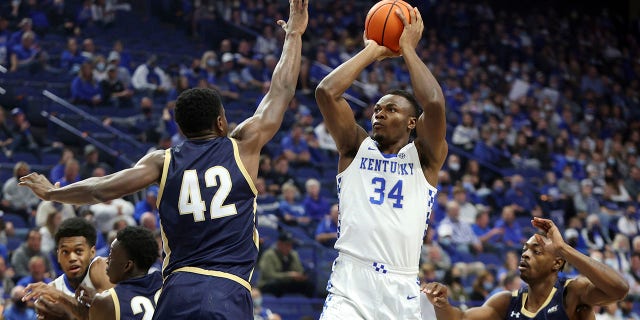 FILE - Kentucky's Oscar Tshiebwe (34) shoots between Mount St. Mary's Malik Jefferson (42) and Josh Reaves (23) during the first half of an NCAA college basketball game in Lexington, Ky., Tuesday, Nov. 16, 2021. Tshiebwe is the unanimous pick as The Associated Press player of the year in the Southeastern Conference, announced Tuesday, March 8, 2022.