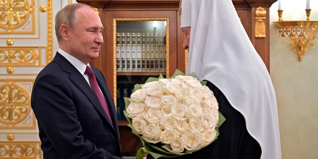 FILE - Russian President Vladimir Putin congratulates Russian Orthodox Church Patriarch Kirill on the 13th anniversary of his enthronement in Moscow, Russia, Tuesday, Feb. 1, 2022. (Alexei Nikolsky, Sputnik, Kremlin Pool Photo via AP)