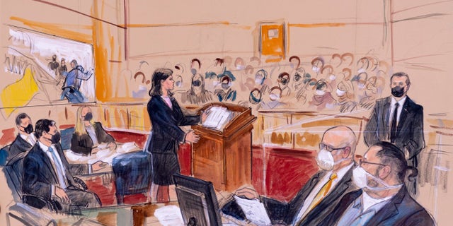 This artist sketch depicts Guy Wesley Reffitt, bottom right, joined by his lawyer William Welch, third from right, listening as prosecutor Risa Berkower, speaks at the podium at center, as a video depicts a handgun on the waist of Reffitt, at left, for members of the jury and audience in Federal Court, in Washington, Monday, March 7, 2022.