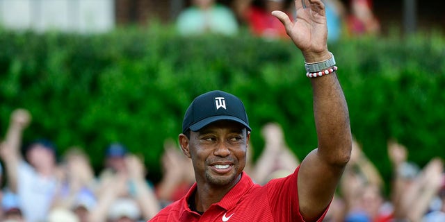 FILE - Tiger Woods celebrates on the 18th green after wining the Tour Championship golf tournament Sunday, Sept. 23, 2018, in Atlanta. Woods will be the star attraction in the World Golf Hall of Fame induction ceremony Wednesday, March 9, 2022.