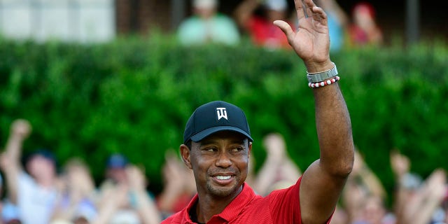 FILE - Tiger Woods celebrates on the 18th green after wining the Tour Championship golf tournament Sunday, Sept. 23, 2018, in Atlanta. Woods will be the star attraction in the World Golf Hall of Fame induction ceremony Wednesday, March 9, 2022.