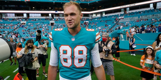 FILE - Miami Dolphins tight end Mike Gesicki (88) walks on the field ahead of an NFL football game against the New England Patriots, Sunday, Jan. 9, 2022, in Miami Gardens, Fla. The Miami Dolphins placed the franchise tag on tight end Mike Gesicki on Tuesday, March 8, which will keep him under contract for the 2022 season.