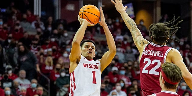 Wisconsin's Johnny Davis (1) shoots against Rutgers' Caleb McConnell (22) during the second half of an NCAA college basketball game Saturday, Feb. 12, 2022, in Madison, Wis. Davis is The Associated Press player of the year in the Big Ten Conference, announced Tuesday, March 8, 2022.