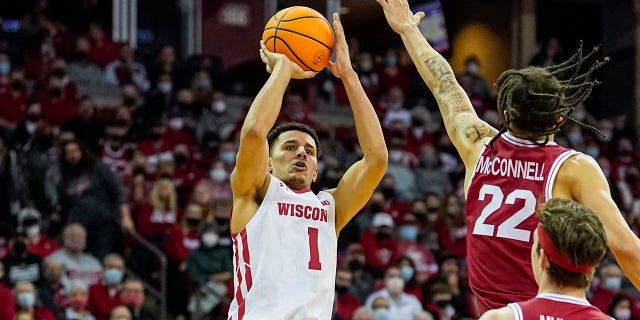 Wisconsin's Johnny Davis (1) shoots against Rutgers' Caleb McConnell (22) during the second half of an NCAA college basketball game Saturday, Feb. 12, 2022, in Madison, Wis. Davis is The Associated Press player of the year in the Big Ten Conference, announced Tuesday, March 8, 2022.