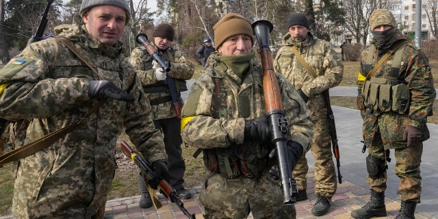 Ukrainian Territorial Defense Forces members hold an anti-tank weapon in a park on the outskirts of Kyiv, Ukraine, March 9, 2022.