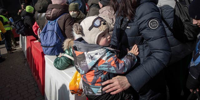 Women and children wait to board a bus heading to Przemysl after fleeing Ukraine. (AP Photo/Visar Kryeziu)