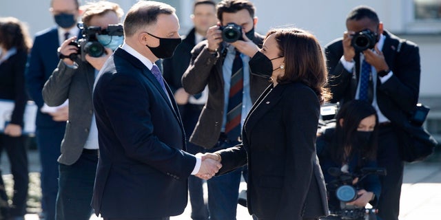 Polish President Andrzej Duda, left, greets US Vice President Kamala Harris as she arrives for meetings at Belwelder Palace, in Warsaw, Poland, Thursday, March 10, 2022. 