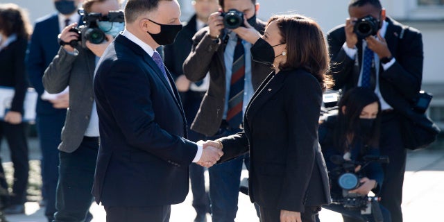 Polish President Andrzej Duda, left, greets US Vice President Kamala Harris as she arrives for meetings at Belwelder Palace, in Warsaw, Poland, Thursday, March 10, 2022. 