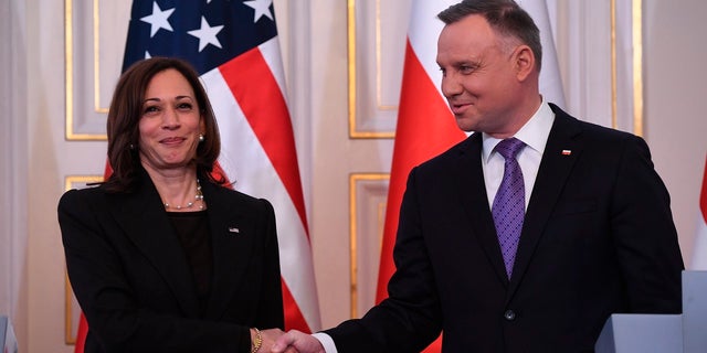 Polish President Andrzej Duda, right, shakes hands with U.S. Vice President Kamala Harris as they meet at Belwelder Palace in Warsaw, Poland, Thursday, March 10, 2022. 