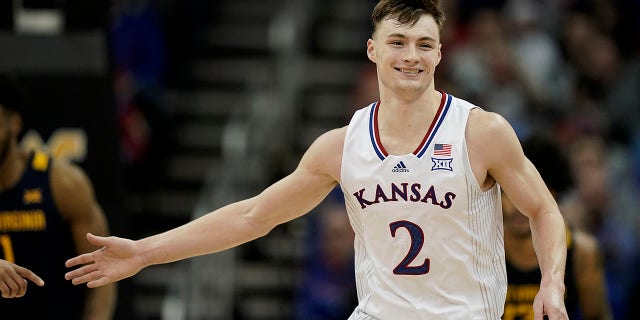 Kansas guard Christian Braun celebrates after a basket during the first half of an NCAA college basketball game against West Virginia in the quarterfinal round of the Big 12 Conference tournament in Kansas City, Mo., 목요일, 행진 10, 2022.