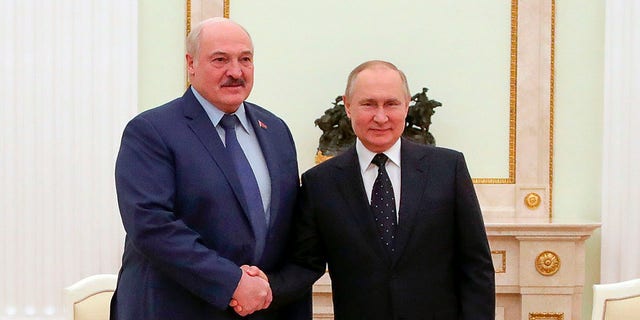 Russian President Vladimir Putin, right, and Belarusian President Alexander Lukashenko pose for a photo during their meeting in Moscow, Russia on Friday, March 11, 2022. 