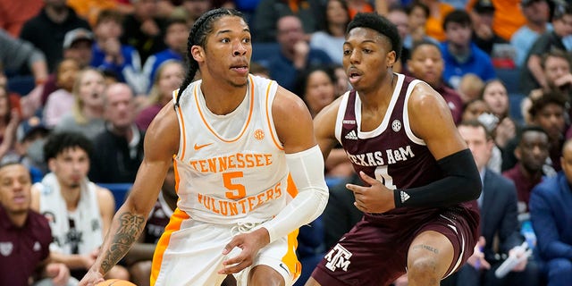 Tennessee guard Zakai Ziegler (5) drives Texas A&M guard Wade Taylor IV (4) during the first run in the NCAA Men's College Basketball Southeast Conference Tournament championship game Sunday, March 13, 2022 in Tampa, Fla.