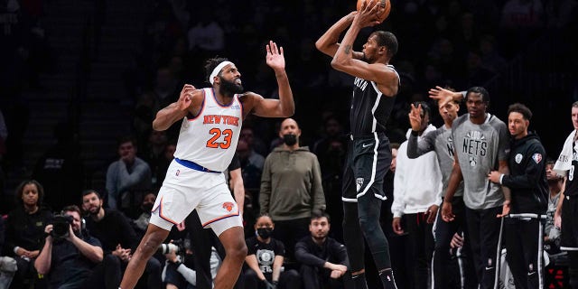 Kevin Durant of the Brooklyn Nets shoots at Mitchell Robinson of the New York Knicks during a game at Barclays Center on March 13, 2022 in New York.