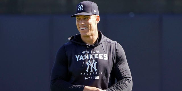 New York Yankees outfielder Aaron Judge shares a laugh with teammates during a spring training baseball workout March 14, 2022, in Tampa, Fla.