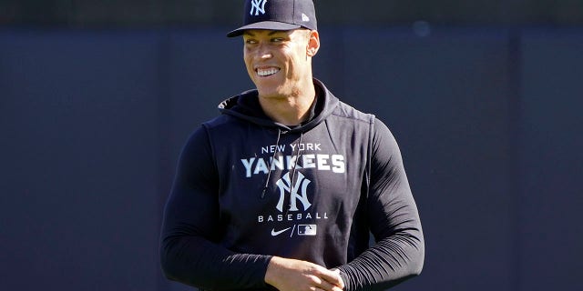 New York Yankees outfielder Aaron Judge shares a laugh with teammates during a spring training baseball workout March 14, 2022, in Tampa, Fla.