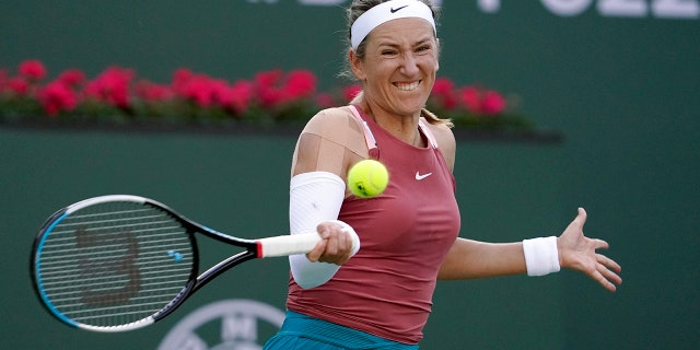 Victoria Azarenka, of Belarus, returns to Elena Rybakina, of Kazakhstan, at the BNP Paribas Open March 14, 2022, in Indian Wells, California.