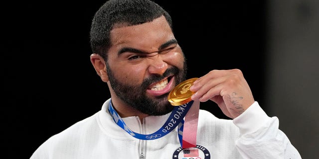 FILE - In this Aug. 6, 2021, file photo, United State's Gable Dan Steveson poses with his gold medal during the medal ceremony for the men's freestyle 125kg wrestling at the 2020 Summer Olympics, in Chiba, Japan. Gable Steveson knew his life had changed after he won an Olympic gold medal in wrestling. But the University of Minnesota star remains shocked by how fans have celebrated him this season during what has amounted to a college farewell tour.