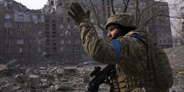 A Ukrainian serviceman guards his position in Mariupol, Ukraine, Saturday, March 12, 2022. (AP Photo/Mstyslav Chernov)